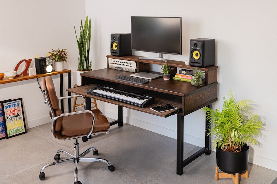 Real wood studio desk with MIDI keyboard, 19" gear, and monitor stand with speakers in a home studio.