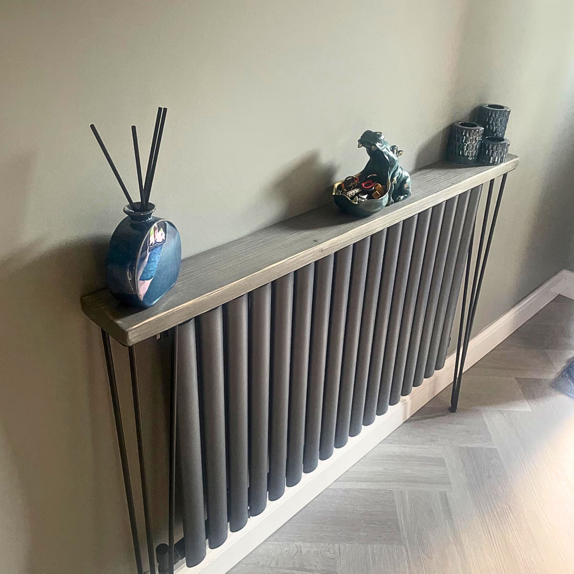 Slim Wooden Radiator Shelf with black Hairpin Legs. Styled with home decorations and reed diffuser.