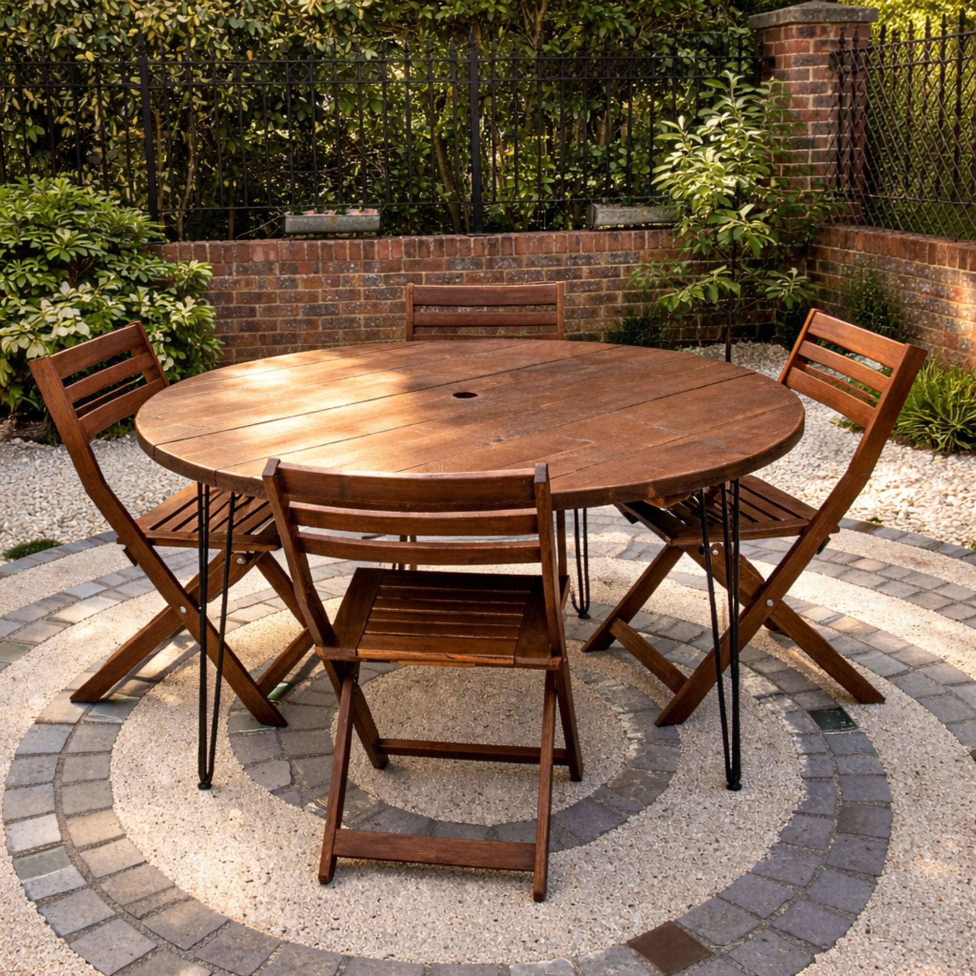 Wooden outdoor dining set with round table and four chairs on a patio.