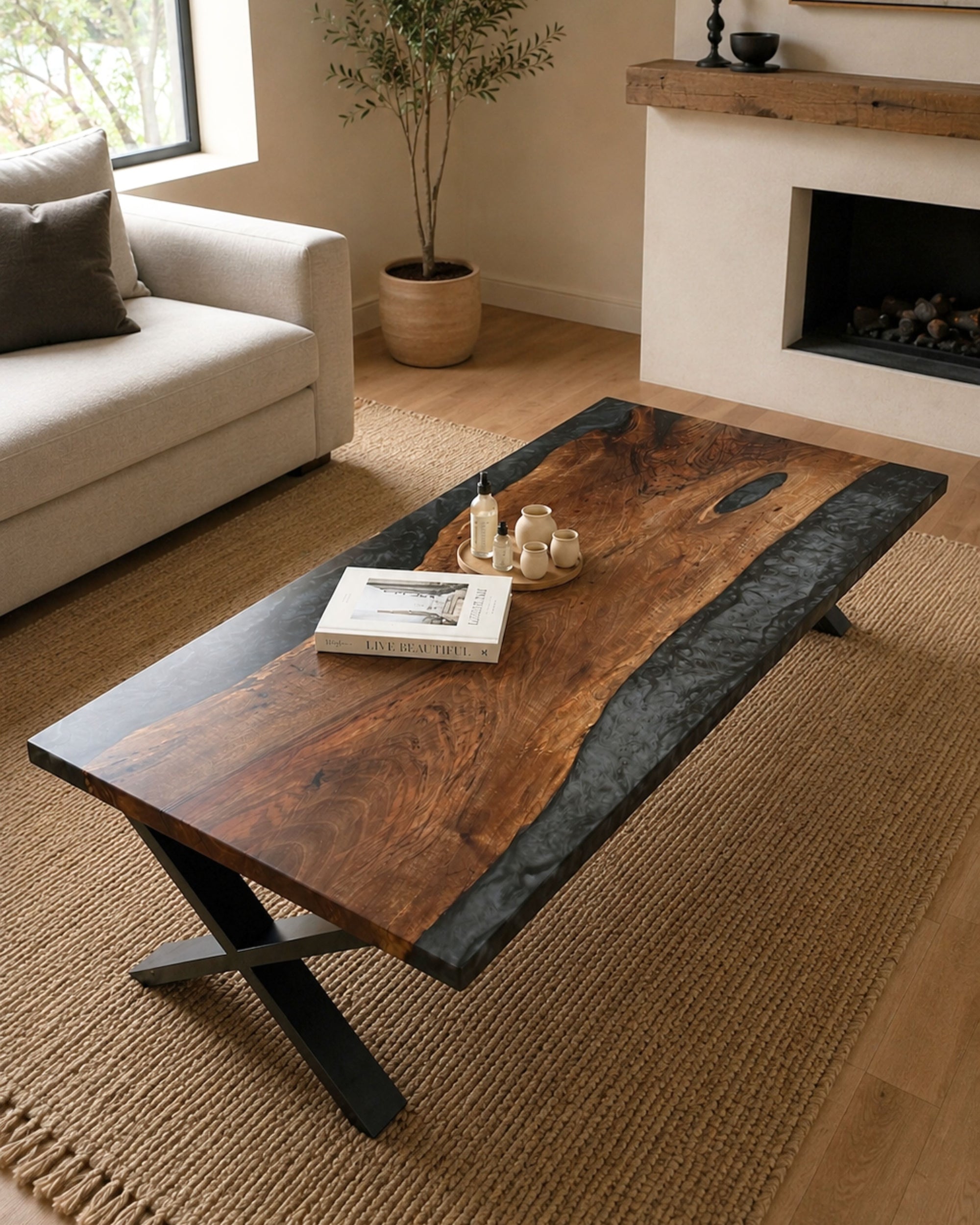 Large walnut statement coffee table with smoked black resin and matte black steel legs in a warm contemporary living room interior.
